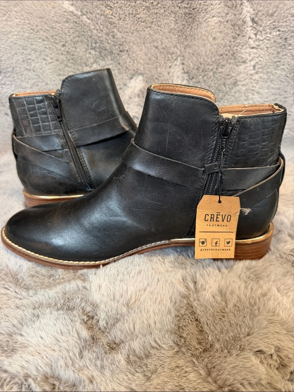 Black leather ankle boots with gold trim